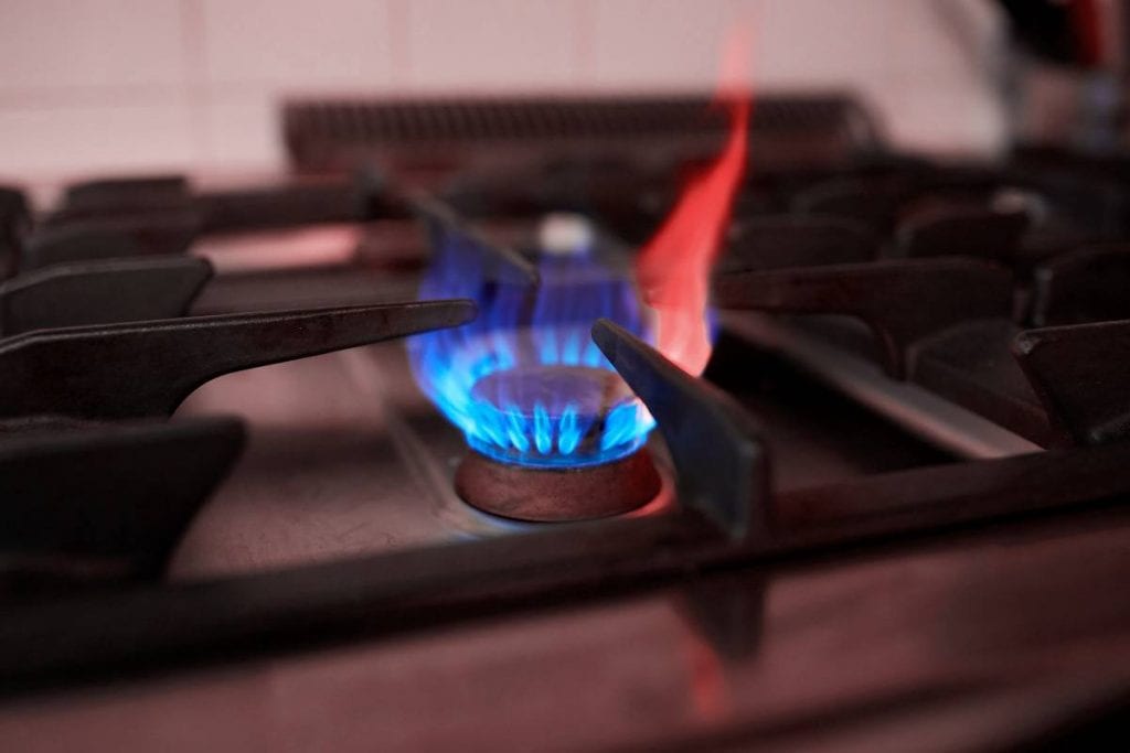 Natural gas burner and large orange and blue flame
